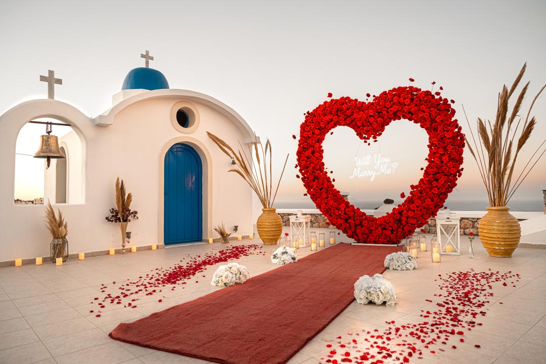 A blue-domed chapel forecourt staged with a rose heart for intimate vows