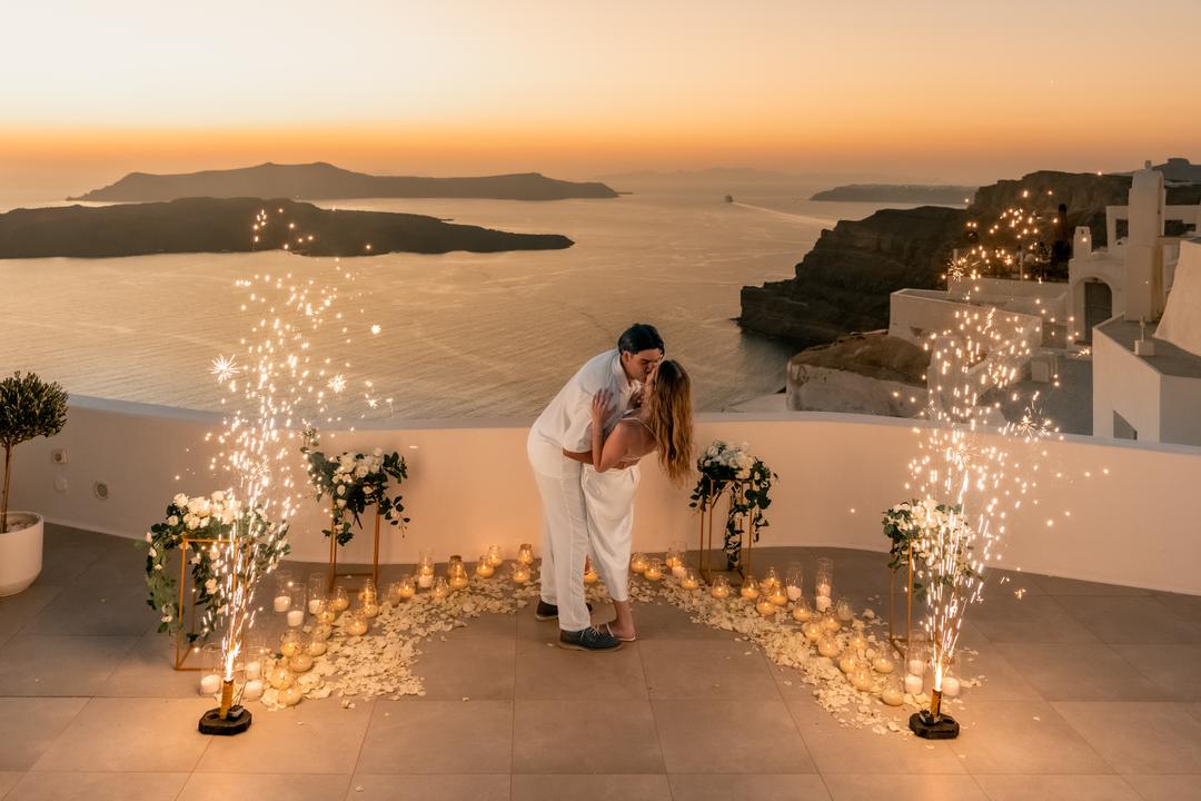 Licensed cold-spark fountains framing a proposal on a terrace at dusk