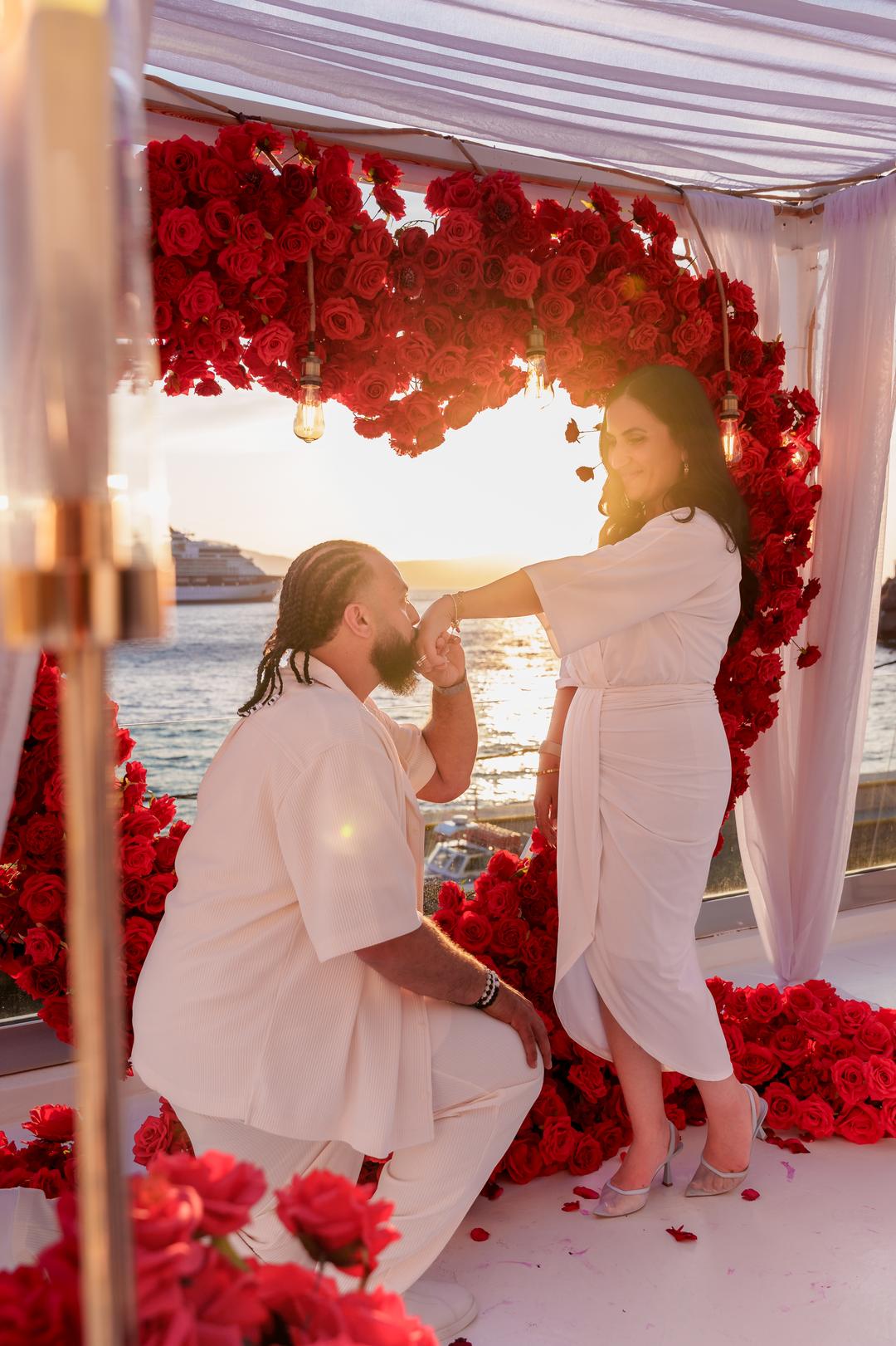 A floral canopy staged for a private evening celebration by the water
